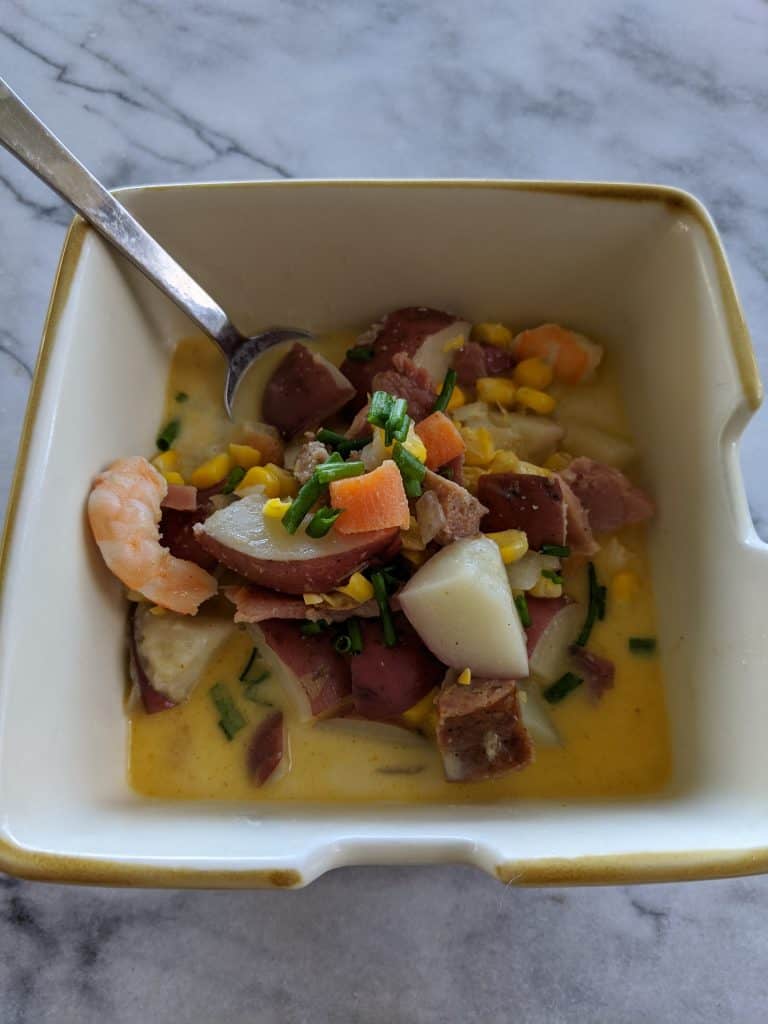 Corn chowder in a bowl with bacon