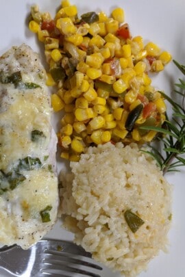 cooked grouper and corn maque choux plated