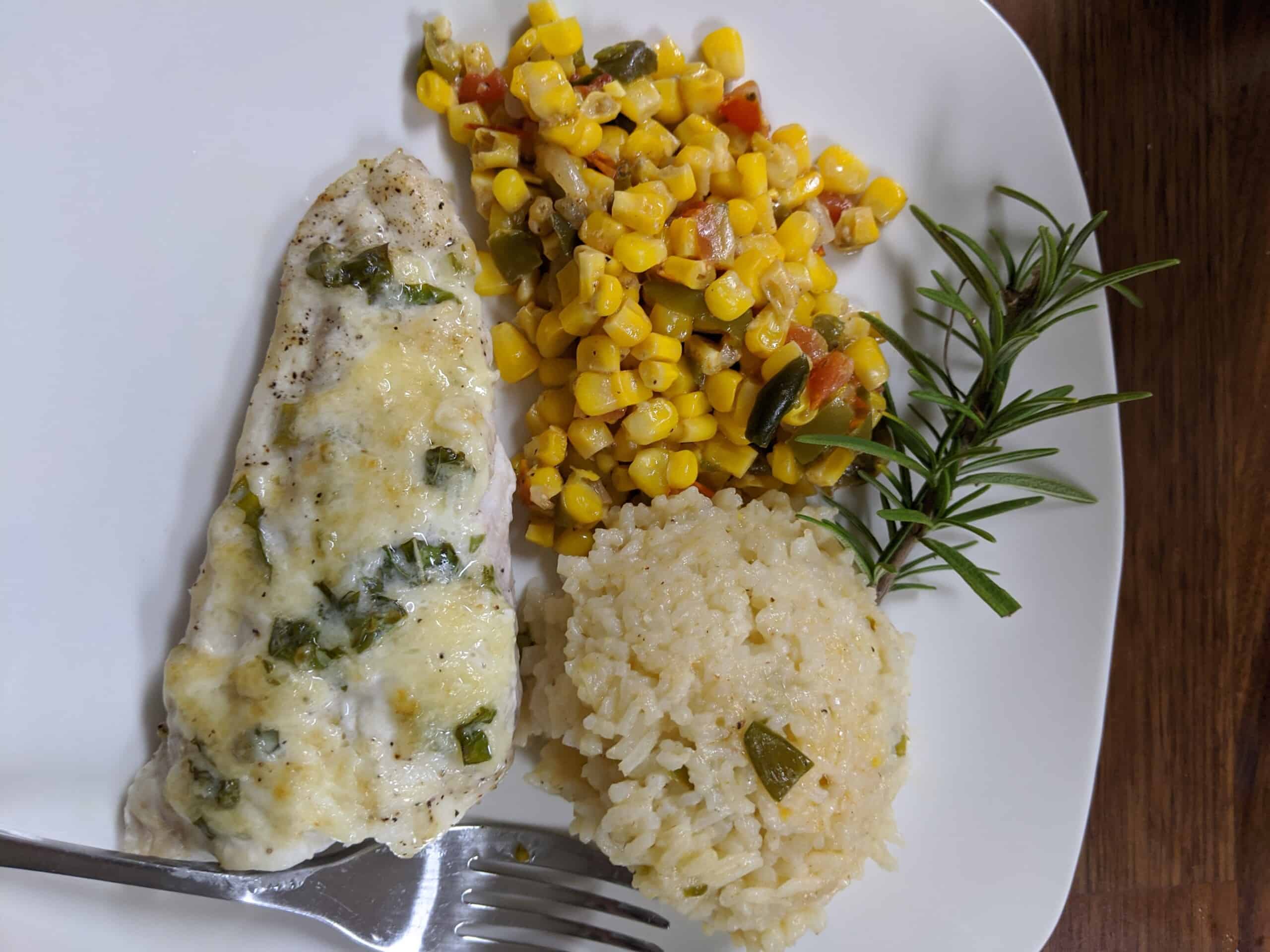 cooked grouper and corn maque choux plated