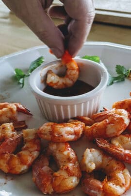 dipping air fryer shrimp into a sauce