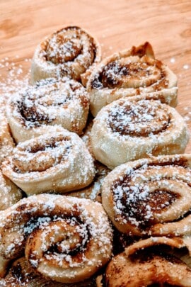 cooked cinnamon rolls with icing sugar on top