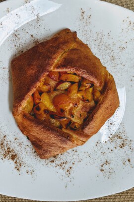 cooked peach galette on plate