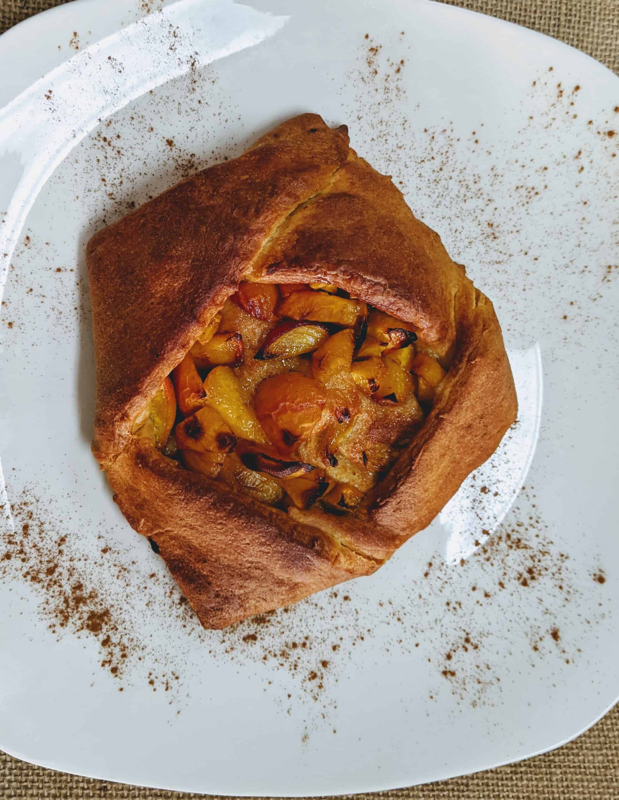 cooked peach galette on plate