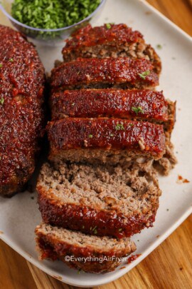 meatloaf with a bourbon sauce sliced on a plate