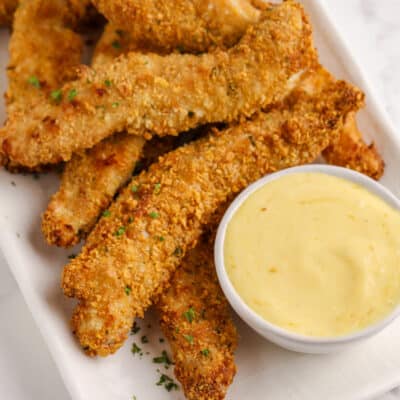 chicken tenders on a plate with mustard dip