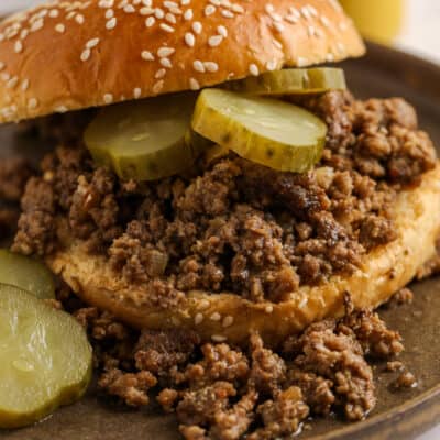 meat on a sesame seed bun with pickles