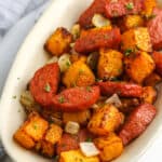 sausage and butternut squash in a serving dish