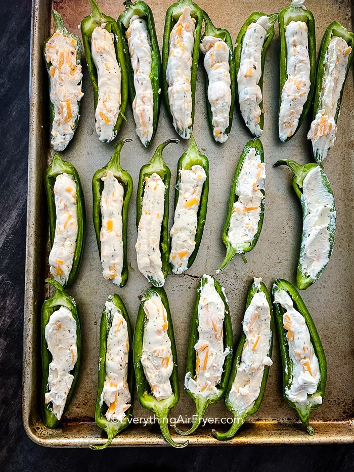 Jalapeno Poppers prepped on a baking sheet