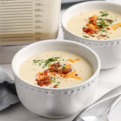 Two prepared bowls of cheesy potato soup