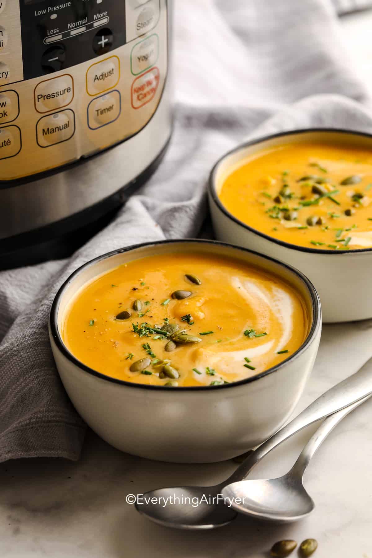 butternut squash soup in a bowl with pepitas