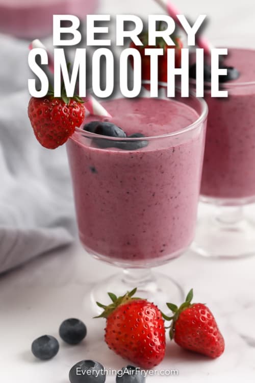 Berry smoothie in a glass with text.