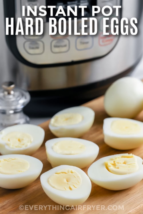 Hard boiled eggs sliced in half in front of an Instant Pot with text.