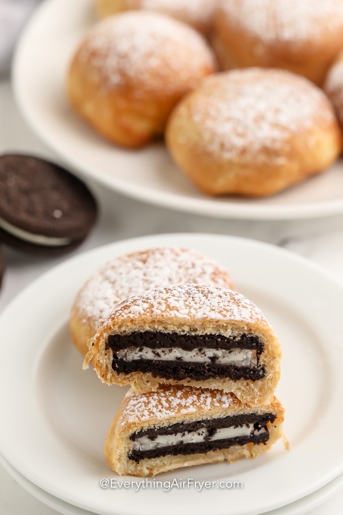 An Air Fryer Oreo dusted with powdered sugar on a plate.