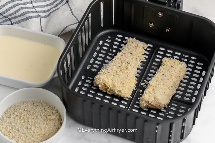 battered fish in an air fryer tray