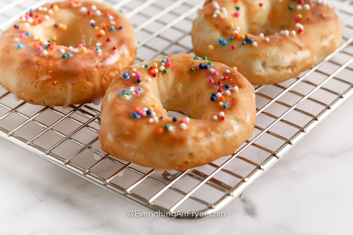 Air Fryer Vanilla glazed Donuts on a drying rack
