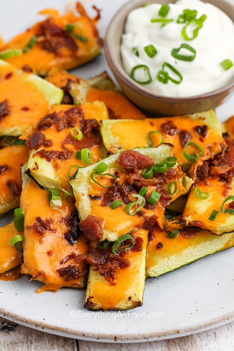 zucchini skins on a plate with bacon and cheese