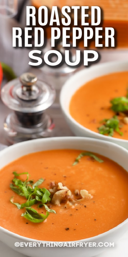 Roasted Red Pepper Soup in bowls topped with chopped basil with text