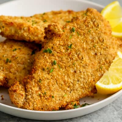 chicken cutlets on a plate with lemon