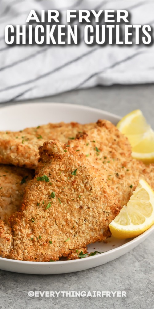 Air Fryer Chicken Cutlets plated with lemon wedges with text.