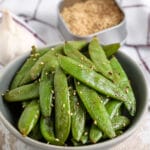 a bowl of air fryer roasted snap peas