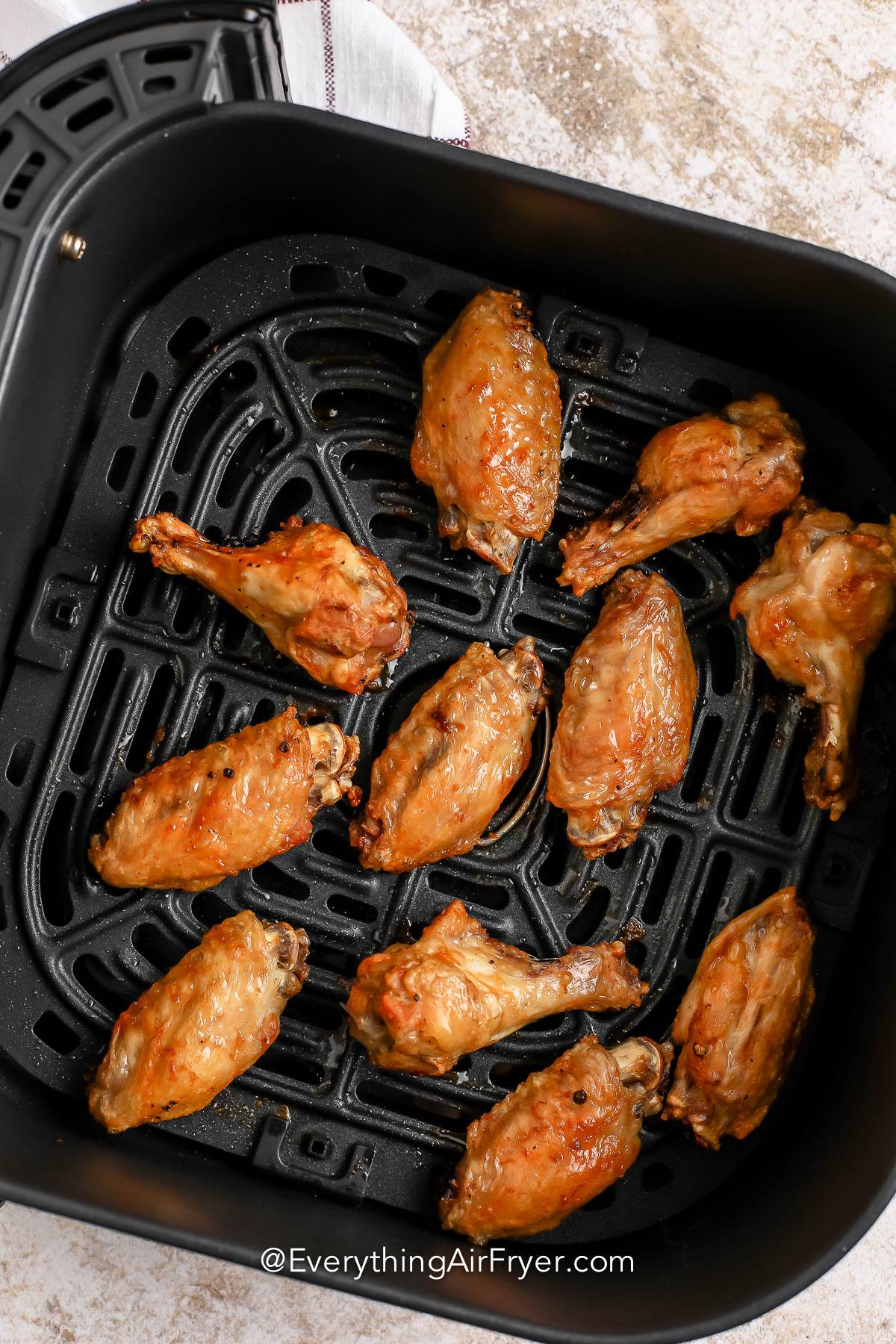 Cooked hot wings in an air fryer basket