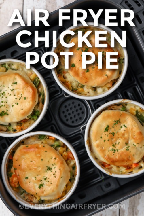 Air Fryer Chicken Pot Pies cooked in an air fryer basket with writing