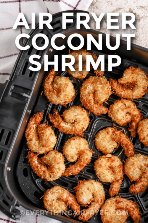 Coconut shrimp in an air fryer basket with writing