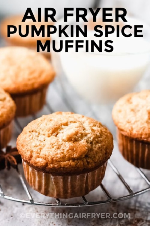 Air fryer pumpkin spice muffins on a cooling rack with writing