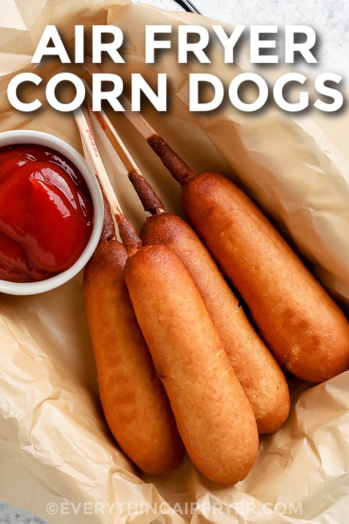 A basket of air fryer corn dogs with ketchup with writing