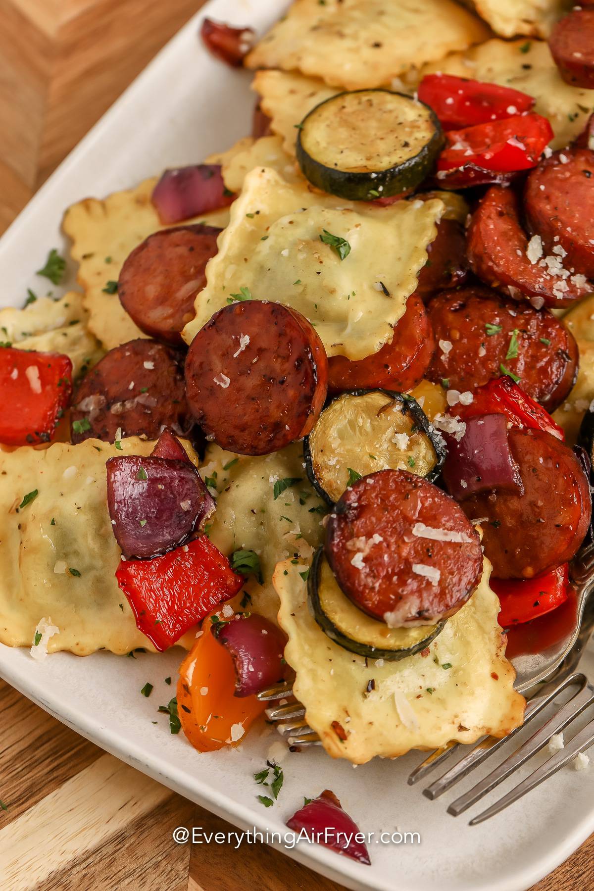 Air Fryer Mixed Vegetables with Ravioli and Sausage being served