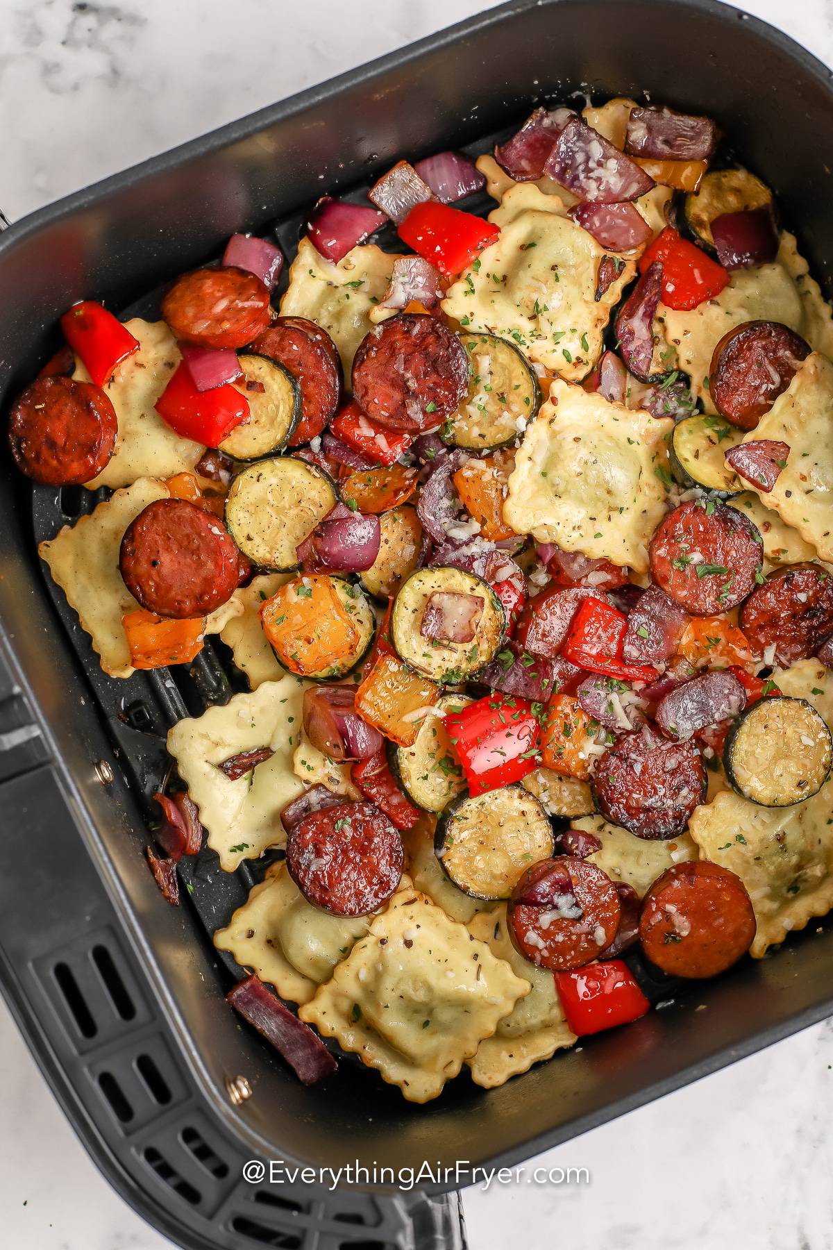 Air Fryer Mixed Vegetables with Ravioli and Sausage cooked in an air fryer basket