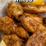 Air Fryer Lemon Pepper Wings garnished with lemon with writing
