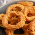 Air Fryer Onion Rings in a bowl with writing