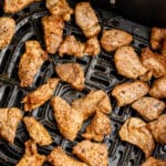 Pork Bites in an air fryer basket with writing
