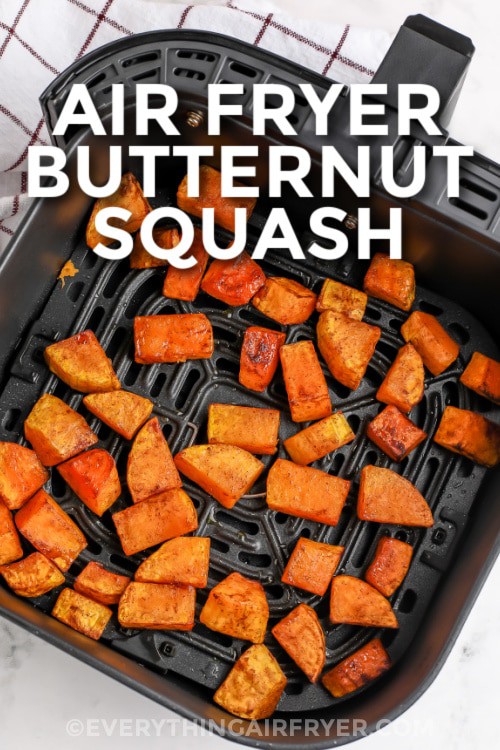 Cubed butternut squash cooked in an air fryer basket with text