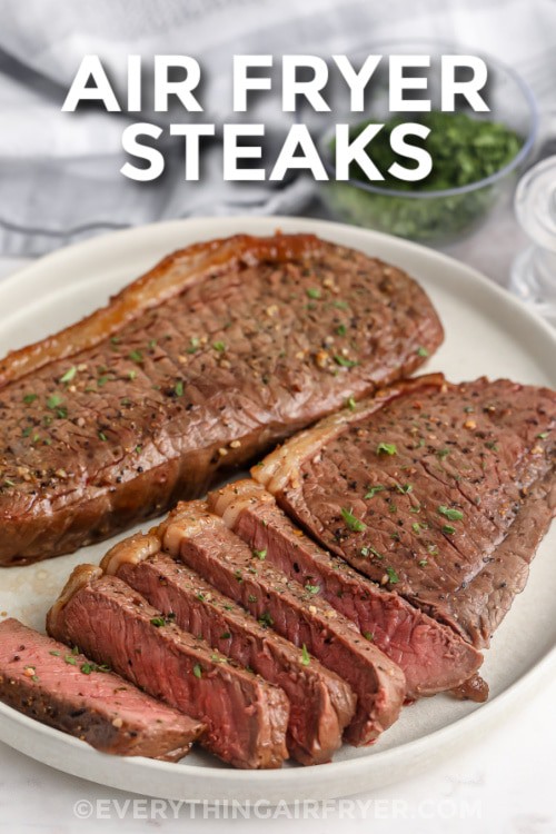 Air fryer steaks sliced on a plate with writing