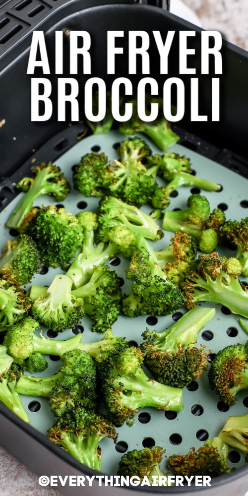 Broccoli in an air fryer basket with writing