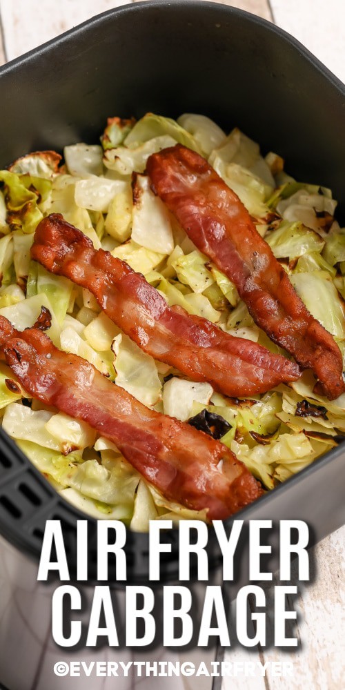 Chopped cabbage topped with bacon in an air fryer basket with writing