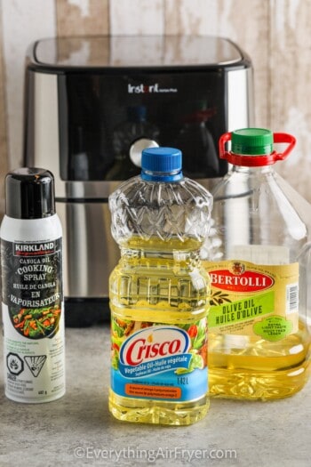 Air Fryer with three types of oil in front of it