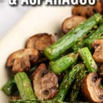 Air Fryer Mushrooms and Asparagus in a serving plate with writing