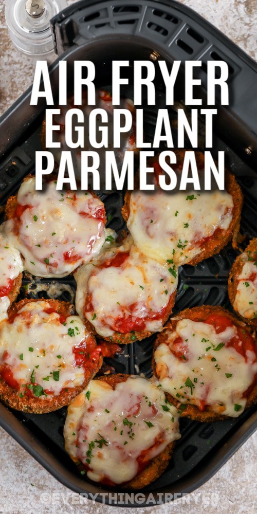 Cooked Eggplant Parmesan in an air fryer basket with a title