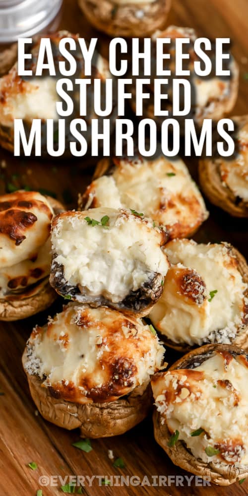 Cheese Stuffed Mushrooms on a cutting board with a titie