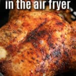 cooking Air Fryer Whole Chicken in the fryer with writing