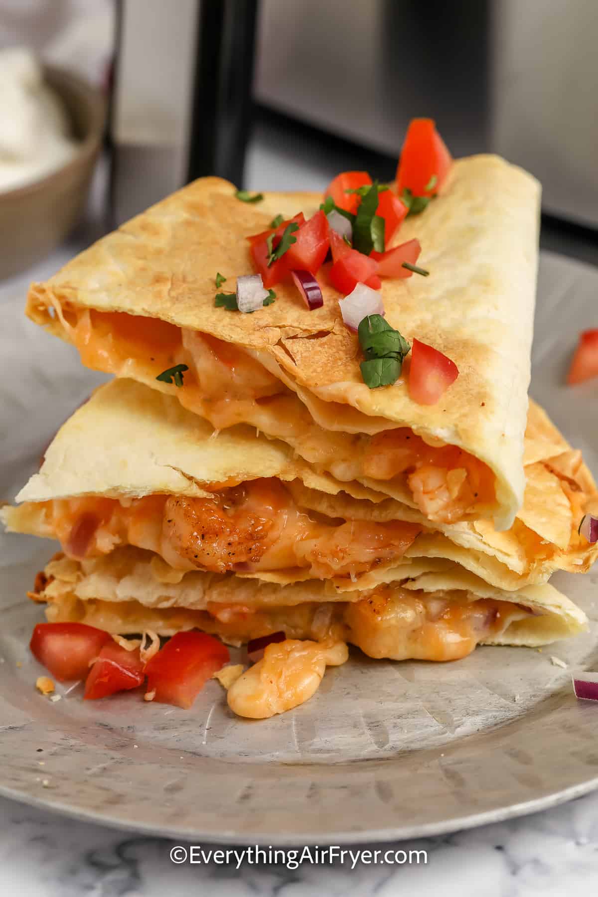 stack of sliced shrimp quesadillas on a plate