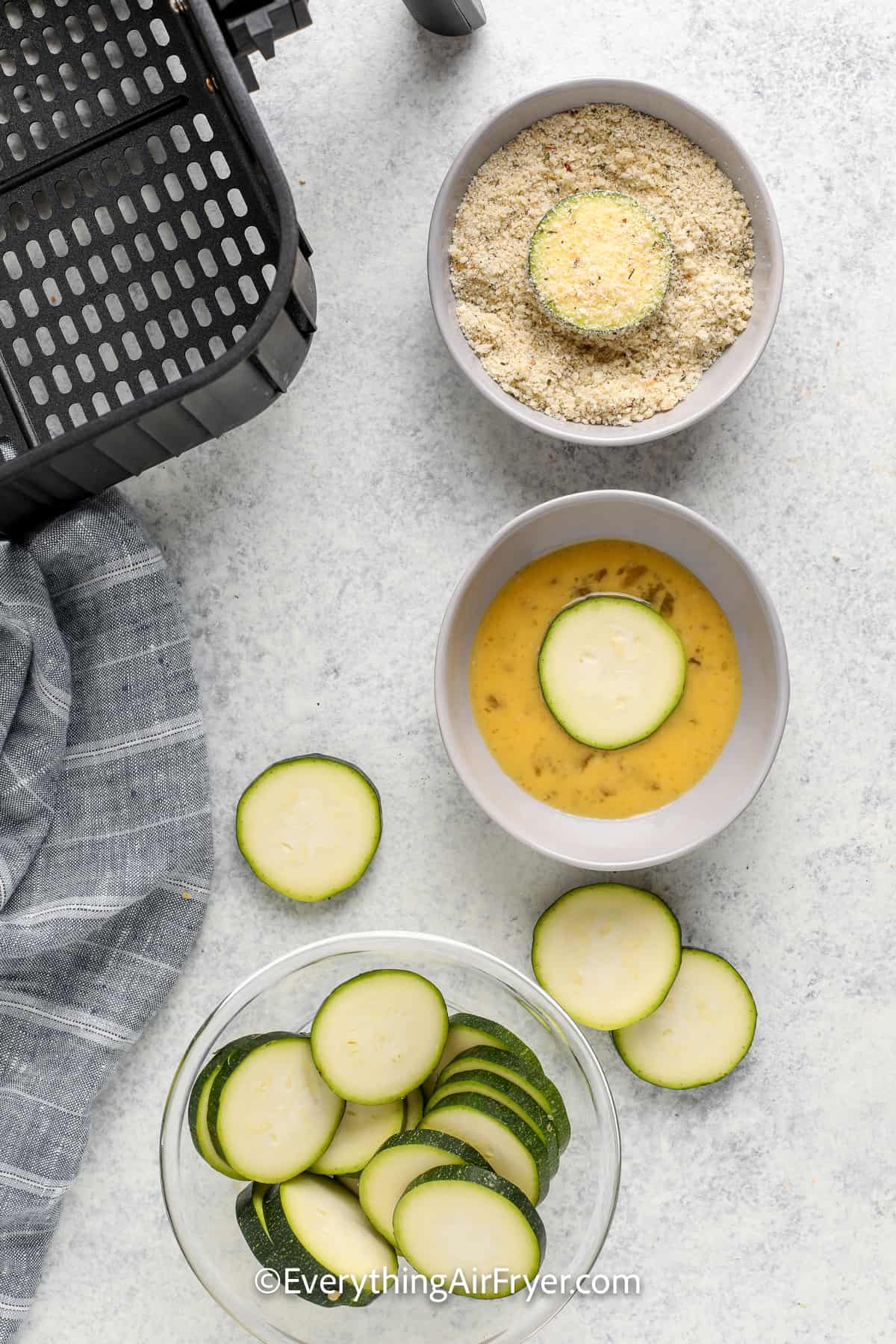 process of adding batter to air fryer zucchini chips