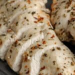 herb chicken breasts on a plate with text
