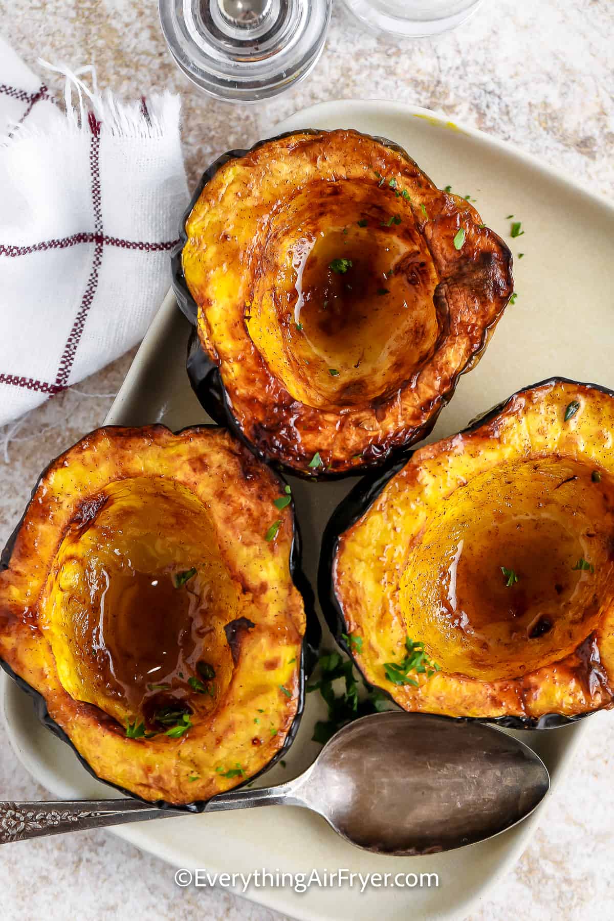 The halves of Air Fryer Acorn Squash on a serving plate.