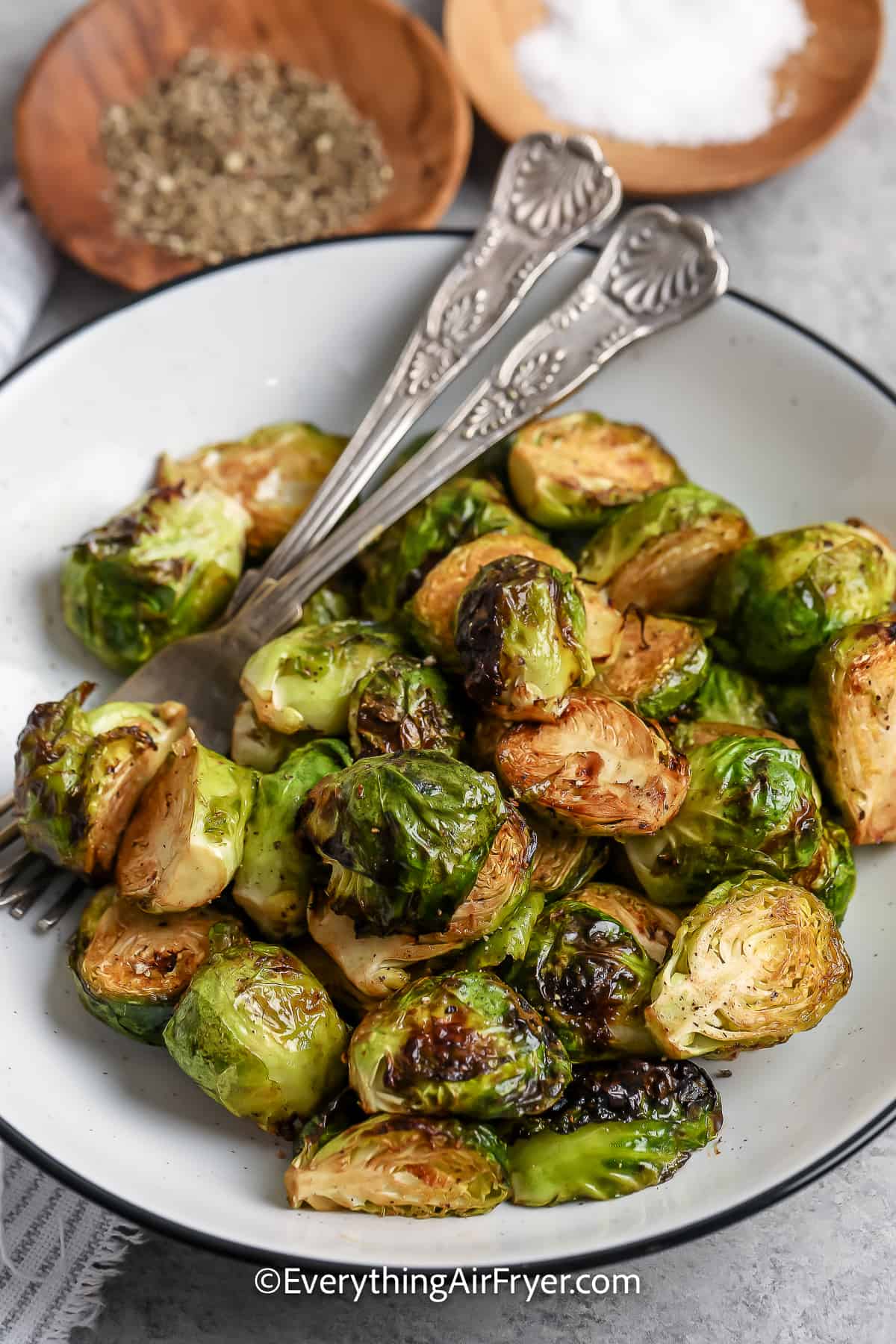 air fryer Brussels sprouts in a bowl with spoons