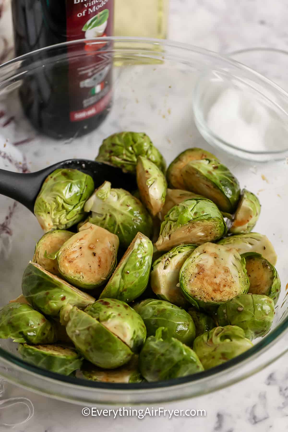 coating brussels sprouts in a bowl