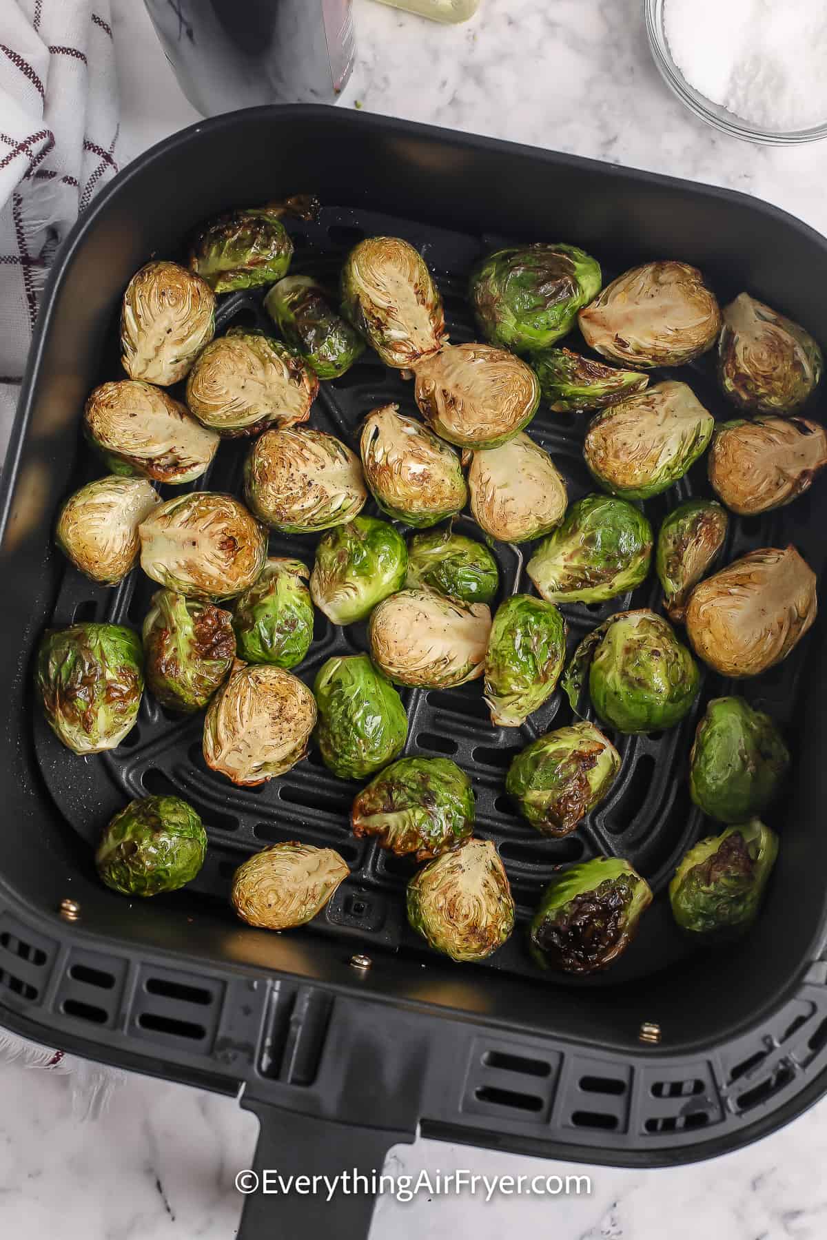 Brussels sprouts cooked in an air fryer basket